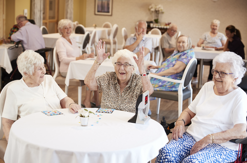 assisted living facility seniors sitting in dining hall